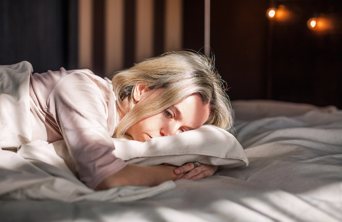 stock-photo-tired-middle-aged-woman-lying-in-bed-can-t-sleep-late-at-morning-with-insomnia-adult-lady-sick-or-2162161347@2x